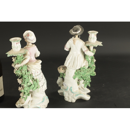 283 - A PAIR OF MID 18TH CENTURY DERBY CANDLESTICK FIGURES male and female companions (27cm high)