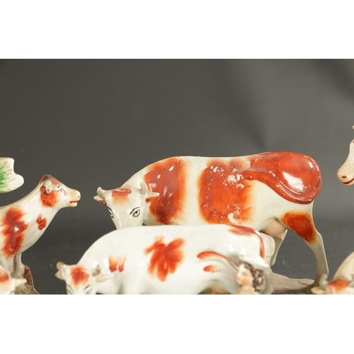 310 - A COLLECTION OF SEVEN MID 19TH CENTURY STAFFORDSHIRE PORCELAIN FIGURAL COW GROUPS (19cm high and sma... 