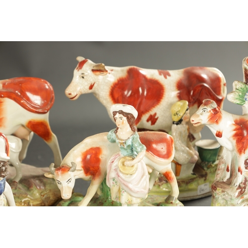 310 - A COLLECTION OF SEVEN MID 19TH CENTURY STAFFORDSHIRE PORCELAIN FIGURAL COW GROUPS (19cm high and sma... 