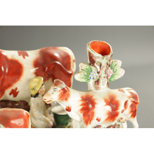 310 - A COLLECTION OF SEVEN MID 19TH CENTURY STAFFORDSHIRE PORCELAIN FIGURAL COW GROUPS (19cm high and sma... 