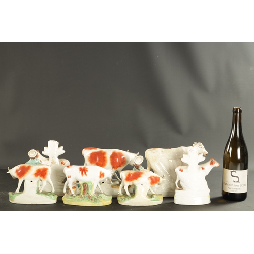 310 - A COLLECTION OF SEVEN MID 19TH CENTURY STAFFORDSHIRE PORCELAIN FIGURAL COW GROUPS (19cm high and sma... 