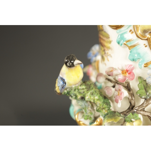 314 - A COALBROOKDALE PORCELAIN VASE ENCRUSTED WITH FLOWERS AND BIRDS WITH RURAL LANDSCAPES (27cm high)