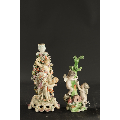 32 - TWO MID 18TH CENTURY DERBY PORCELAIN FIGURE GROUPS one of two putti, the other a candlestick figure ... 