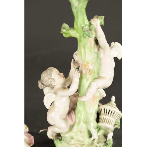 32 - TWO MID 18TH CENTURY DERBY PORCELAIN FIGURE GROUPS one of two putti, the other a candlestick figure ... 