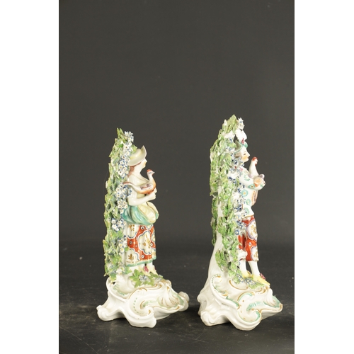 324 - A PAIR OF LATE 18TH CENTURY DERBY BOCAGE FIGURES of farmer and wife (25cm high)