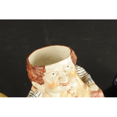 329 - A STAFFORDSHIRE TABACO JAR IN THE FORM OF A MAN AND A SMALLER SIMILAR EXAMPLE (15cm and 8cm high )