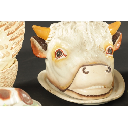 338 - A STAFFORDSHIRE BULLS HEAD TONGE STAND AND COVER along with A STAFFORDSHIRE BUTTER TUB modelled as a... 