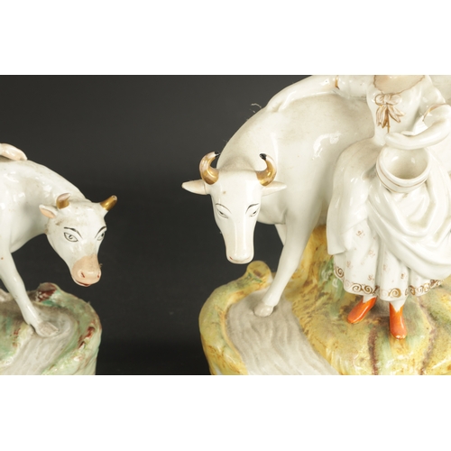 344 - A PAIR OF MID 19TH CENTURY STAFFORDSHIRE FIGURAL GROUPS comprising a cow, shepherd and milkmaid and ... 