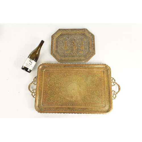 412 - A 19TH CENTURY INDIAN ENGRAVED BRASS TWO-HANDLED TRAY with a peacock centre and a similar pierced br... 