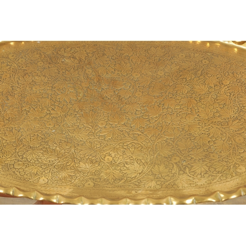 413 - A LARGE 20TH CENTURY EASTERN LARGE OVAL TRAY TOP COFFEE TABLE with embossed leaf work decoration on ... 