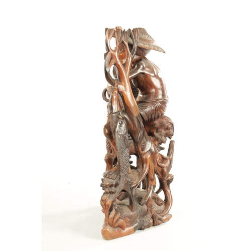 416 - A 19TH CENTURY CHINESE HARDWOOD CARVED FIGURAL SCULPTURE of a fisherman or a flowering foliated base... 