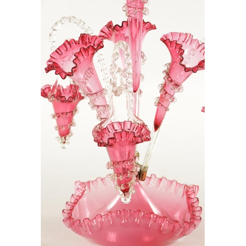 8 - A 19TH CENTURY CRANBERRY GLASS EPERGNE with fluted bodies and hanging baskets (53cm high )