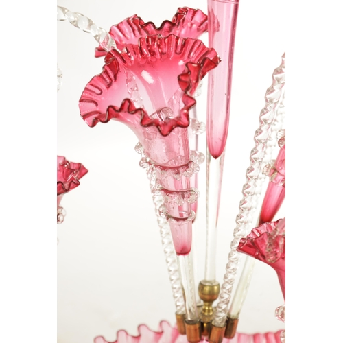 8 - A 19TH CENTURY CRANBERRY GLASS EPERGNE with fluted bodies and hanging baskets (53cm high )