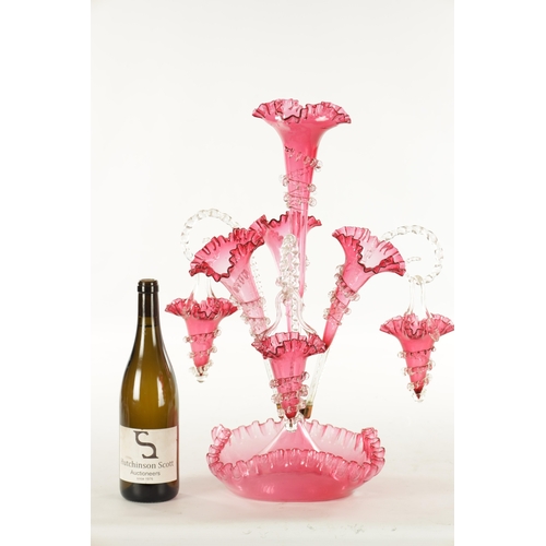 8 - A 19TH CENTURY CRANBERRY GLASS EPERGNE with fluted bodies and hanging baskets (53cm high )