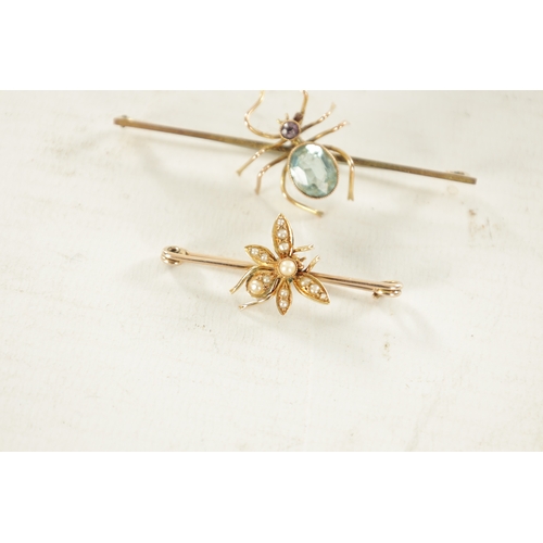 456 - TWO VINTAGE 9CT GOLD SPIDER BAR BROOCHES: the larger brooch has a pivoting aquamarine and pink tourm... 