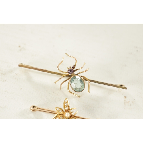 456 - TWO VINTAGE 9CT GOLD SPIDER BAR BROOCHES: the larger brooch has a pivoting aquamarine and pink tourm... 