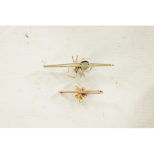 456 - TWO VINTAGE 9CT GOLD SPIDER BAR BROOCHES: the larger brooch has a pivoting aquamarine and pink tourm... 