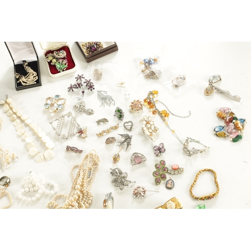 467 - A LARGE COLLECTION OF VINTAGE COSTUME JEWELLERY comprising brooches, necklaces, pendants, earrings a... 