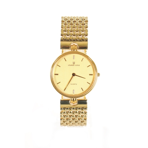 509 - A VINTAGE GOLD PLATED UNIVERSAL-GENEVE WRISTWATCH with original bracelet, the gold honeycomb dial wi... 