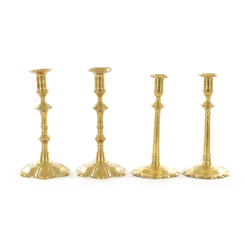 543 - A GOOD PAIR OF EARLY GEORGIAN PETAAL BASED BRASS CANDLESTICKS with ringed knopped stems TOGETHER WIT... 