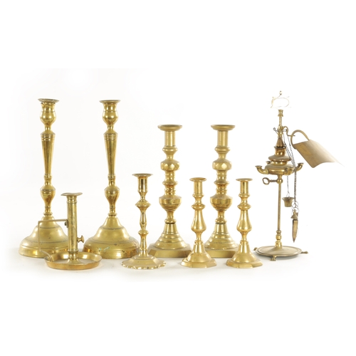 544 - THREE PAIRS OF 19TH CENTURY BRASS CANDLESTICKS a brass chamberstick, an early candlestick and a bras... 