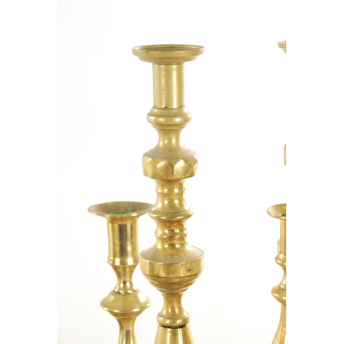 544 - THREE PAIRS OF 19TH CENTURY BRASS CANDLESTICKS a brass chamberstick, an early candlestick and a bras... 