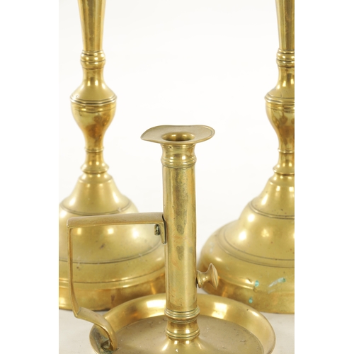 544 - THREE PAIRS OF 19TH CENTURY BRASS CANDLESTICKS a brass chamberstick, an early candlestick and a bras... 