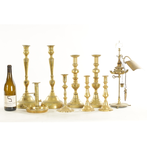 544 - THREE PAIRS OF 19TH CENTURY BRASS CANDLESTICKS a brass chamberstick, an early candlestick and a bras... 