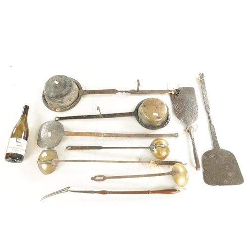 545 - A COLLECTION OF EARLY BRASS AND IRONWORK KITCHENALIA including two down hearth pans, oven slices, la... 