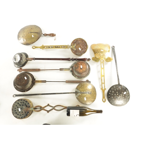 553 - A COLLECTION OF GEORGIAN AND VICTORIAN BRASS AND IRONWORK KITCHEN WARE comprising skimmers, two ches... 