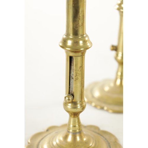 555 - A COLLECTION OF FOUR PAIRS OF EARLY 18TH CENTURY BRASS CANDLESTICKS including a pair with side eject... 