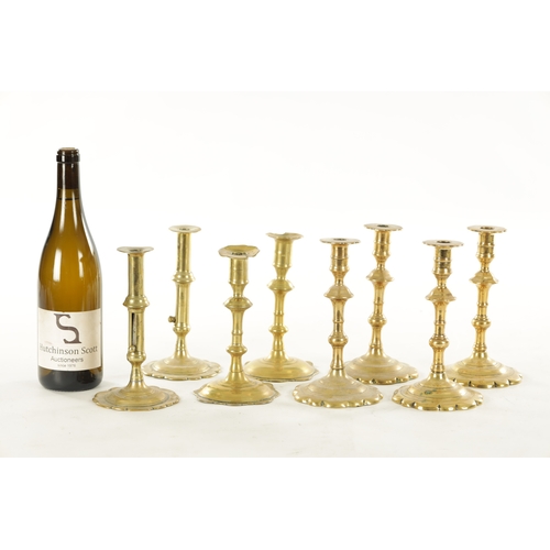 555 - A COLLECTION OF FOUR PAIRS OF EARLY 18TH CENTURY BRASS CANDLESTICKS including a pair with side eject... 