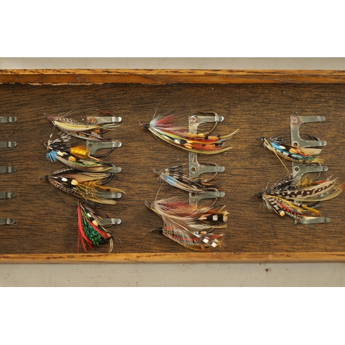 587 - A VINTAGE LEATHER FISHING TACKLE BOX WITH VARIOUS SALMON FLIES having a hinged lid with brass lock, ... 