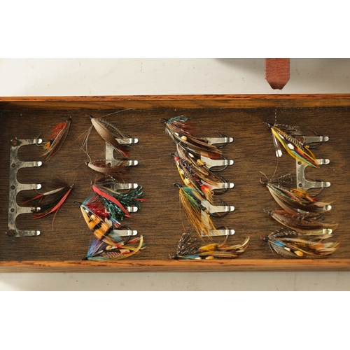 587 - A VINTAGE LEATHER FISHING TACKLE BOX WITH VARIOUS SALMON FLIES having a hinged lid with brass lock, ... 