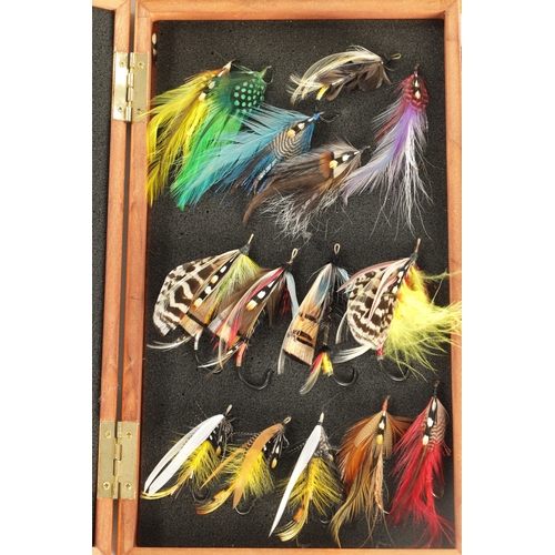 599 - A COLLECTION OF FOUR CASES CONTAINING VARIOUS VINTAGE SALMON FISHING FLIES (longest box measures 66c... 