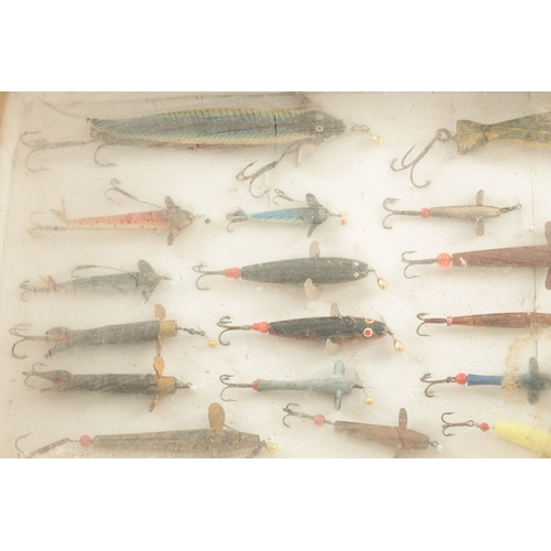 630 - A LARGE COLLECTION OF VINTAGE FISHING LURES mostly displayed in glazed cases and boxes by Hardy and ... 