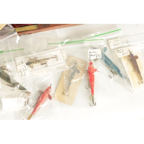 630 - A LARGE COLLECTION OF VINTAGE FISHING LURES mostly displayed in glazed cases and boxes by Hardy and ... 