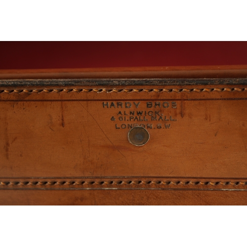 654 - A LARGE 19TH CENTURY LEATHER FISHING BOX BY HARDY BROS. with tooled leather decoration and brass loc... 