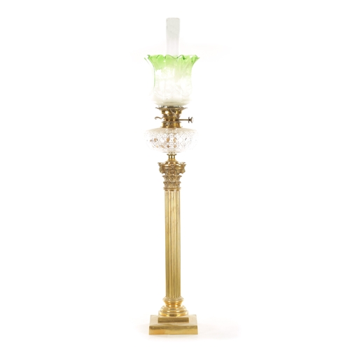 666 - A 19TH CENTURY BRASS CORINTHIAN COLUMN OIL LAMP with a glass tinted-shaped glass shade and cut glass... 