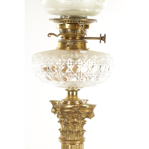 666 - A 19TH CENTURY BRASS CORINTHIAN COLUMN OIL LAMP with a glass tinted-shaped glass shade and cut glass... 