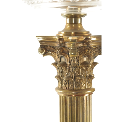 666 - A 19TH CENTURY BRASS CORINTHIAN COLUMN OIL LAMP with a glass tinted-shaped glass shade and cut glass... 