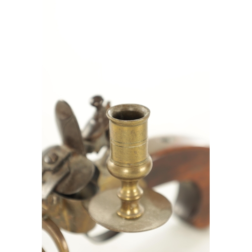 678 - A FLINTLOCK TINDER LIGHTER with side candle holder and walnut handle (13.5cm wide 10cm high )