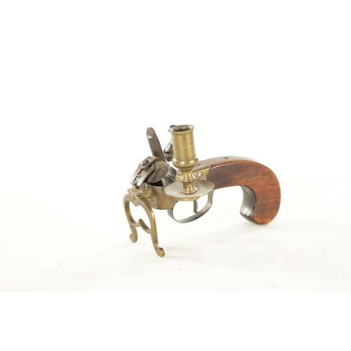 678 - A FLINTLOCK TINDER LIGHTER with side candle holder and walnut handle (13.5cm wide 10cm high )