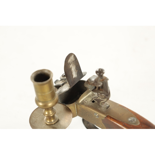 678 - A FLINTLOCK TINDER LIGHTER with side candle holder and walnut handle (13.5cm wide 10cm high )