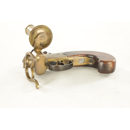 678 - A FLINTLOCK TINDER LIGHTER with side candle holder and walnut handle (13.5cm wide 10cm high )