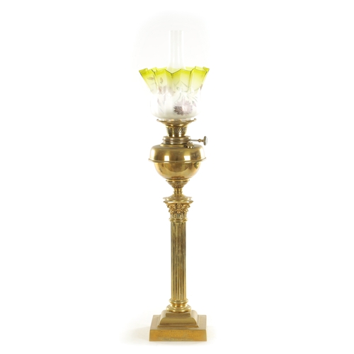 689 - A 19TH CENTURY BRASS CORINTHIAN COLUMN OIL LAMP with yellow tinted glass shade and solid brass reser... 