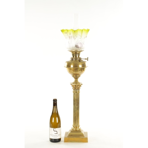 689 - A 19TH CENTURY BRASS CORINTHIAN COLUMN OIL LAMP with yellow tinted glass shade and solid brass reser... 