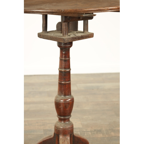 823 - A GEORGE III OAK CIRCULAR TILT TOP TRIPOD TBALE with a revolving bird cage on a ringed turned stem (... 