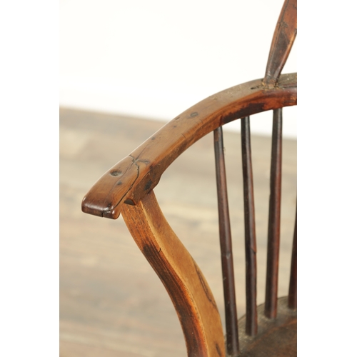 826 - AN EARLY 19TH CENTURY LOW BACK YEW WOOD WINDSOR CHAIR with pierced slat back, saddle seat with turne... 