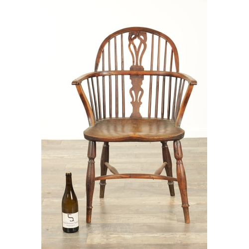 826 - AN EARLY 19TH CENTURY LOW BACK YEW WOOD WINDSOR CHAIR with pierced slat back, saddle seat with turne... 